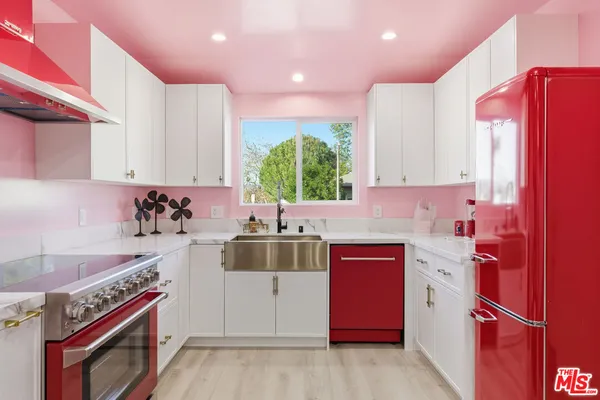 a kitchen with stainless steel appliances granite countertop a stove sink and cabinets