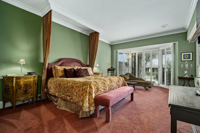 a bedroom with two beds and large window