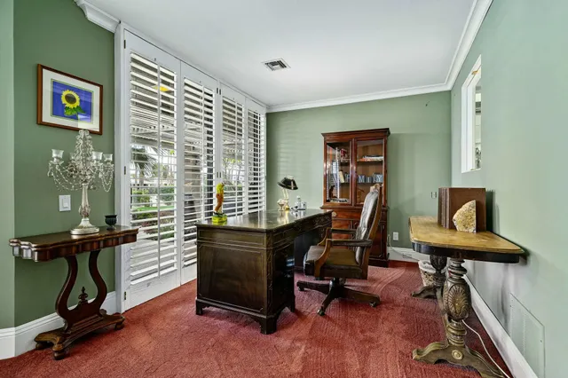 a view of a workspace with furniture and a window