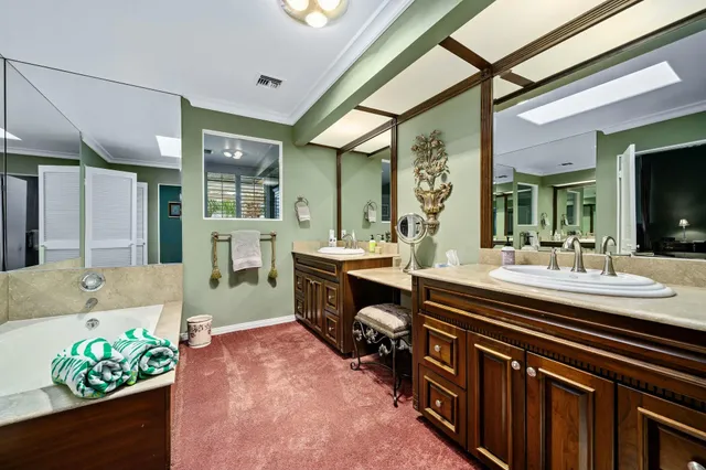 a spacious bathroom with a sink mirror and a bath tub