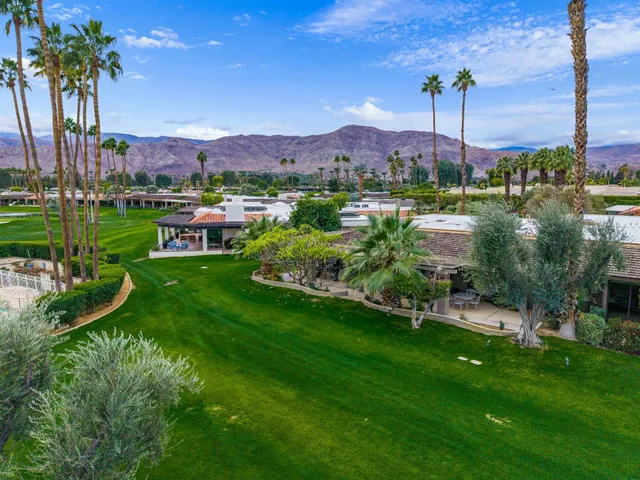 a swimming pool with outdoor seating and yard
