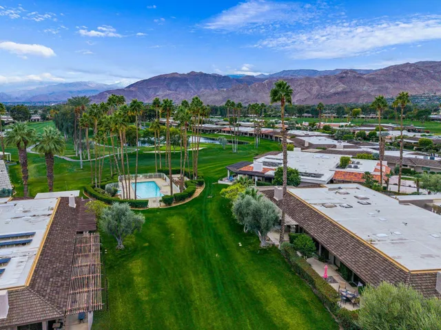an aerial view of a house with a backyard