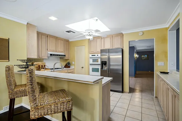 a kitchen with a refrigerator a sink and cabinets