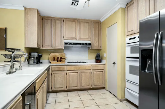 a kitchen with a sink appliances and cabinets