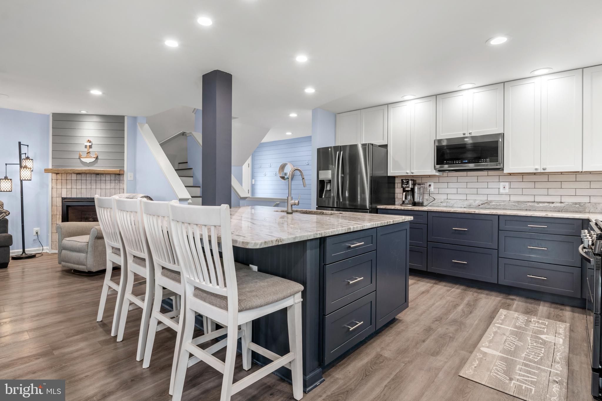 3608 Galloway Road Baltimore, MD 21220 - Photo 63 of 136 a kitchen with stainless steel appliances kitchen island granite countertop a table chairs sink refrigerator and microwave