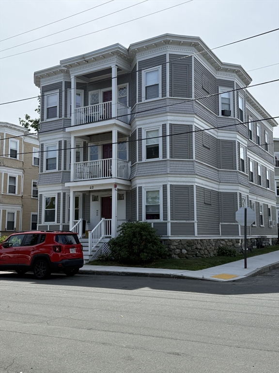 a front view of a residential apartment building with a yard