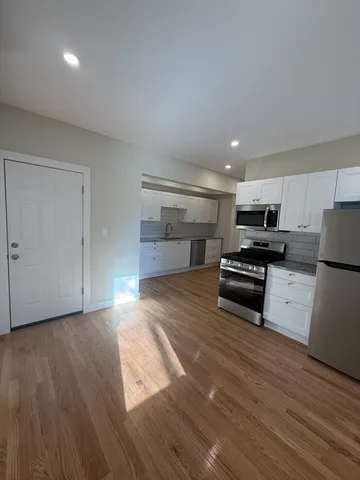 a kitchen with stainless steel appliances a refrigerator and a stove top oven
