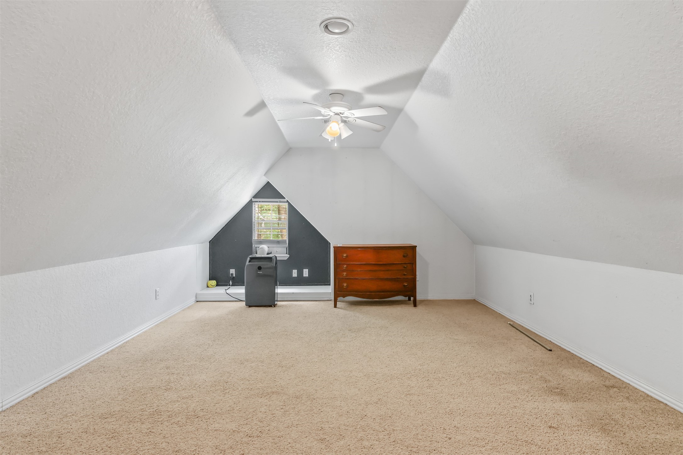 11692 Clark Lane Conroe, TX 77385 - Photo 19 of 35 Another view of the room with "A" frame style ceiling, double ceiling fans, carpet and window.