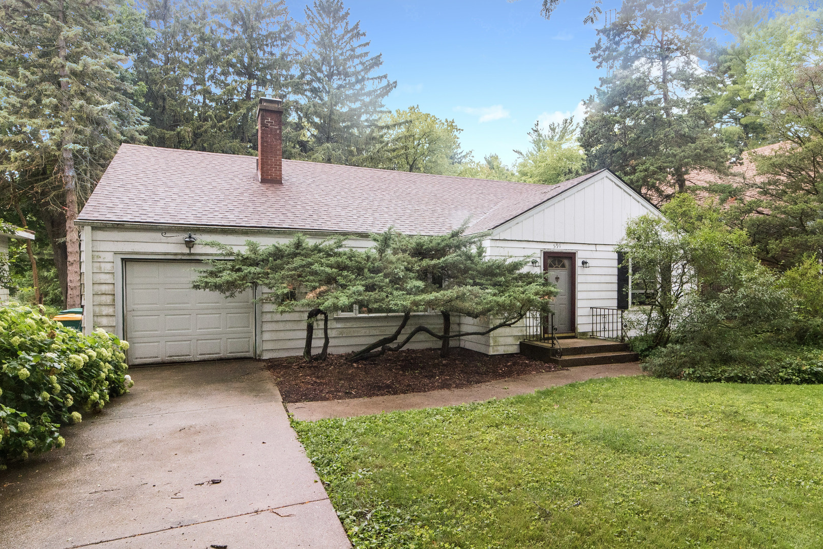 a view of a house with a garden and yard