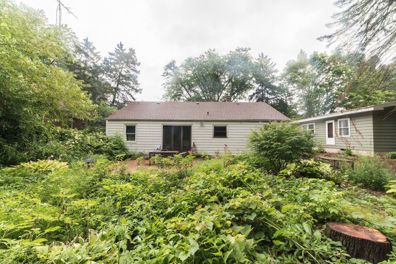 591 Normal Road DeKalb, IL 60115 - Photo 22 of 24 a aerial view of a house with yard and trees in the background