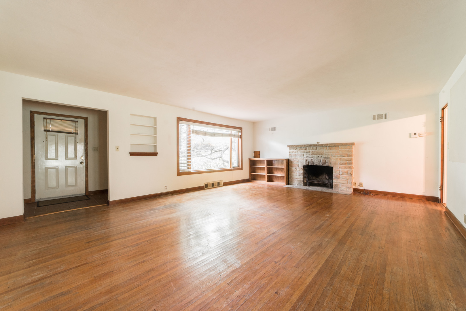 591 Normal Road DeKalb, IL 60115 - Photo 5 of 24 a view of empty room with fireplace and wooden floor
