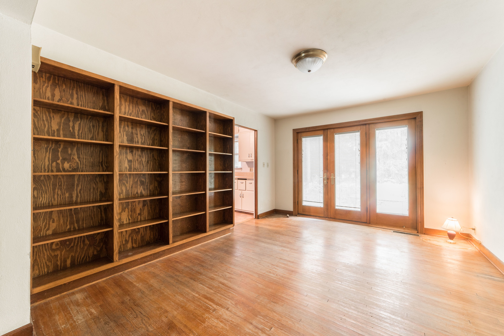 591 Normal Road DeKalb, IL 60115 - Photo 7 of 24 a view of an empty room with a window and wooden floor