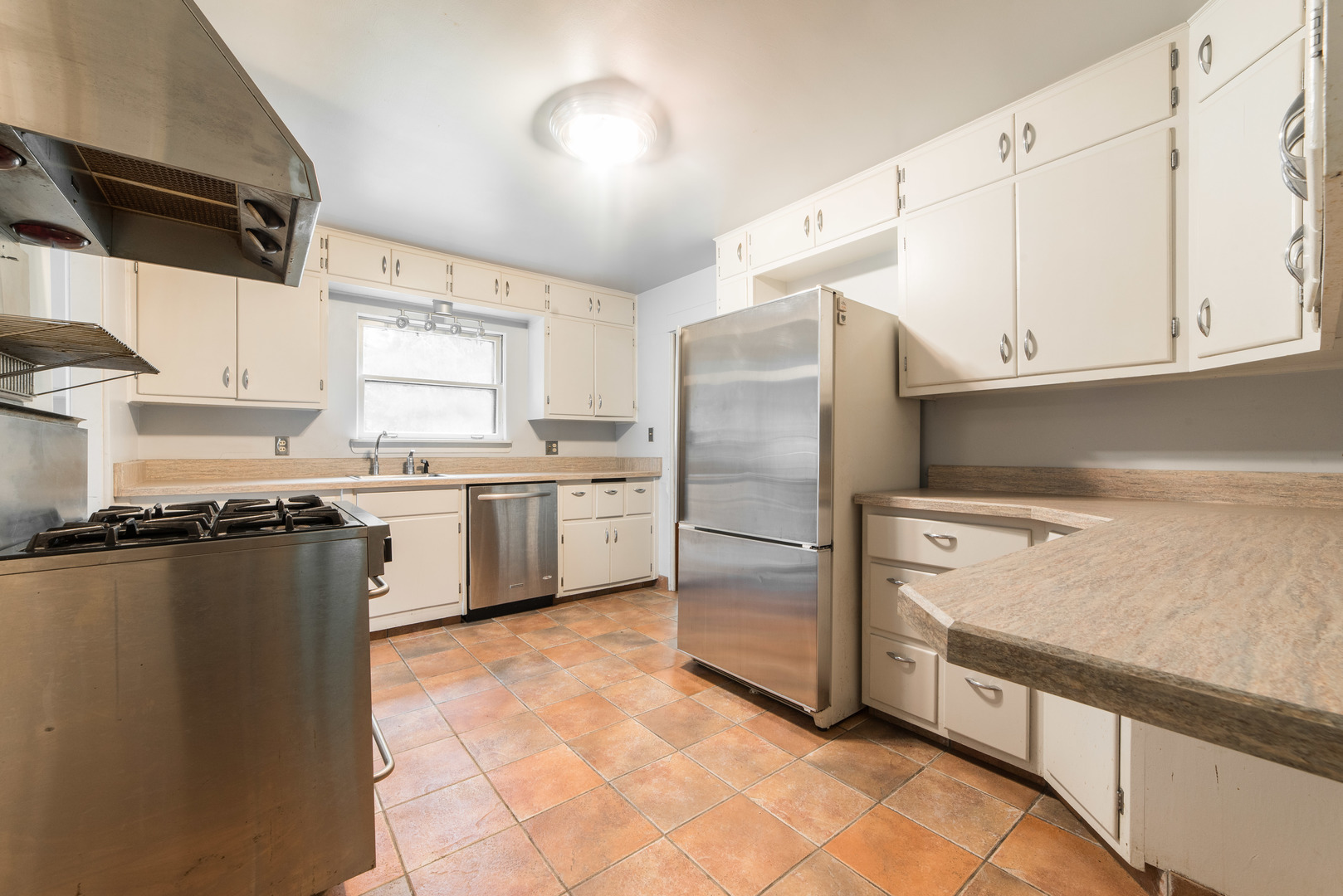 591 Normal Road DeKalb, IL 60115 - Photo 9 of 24 a kitchen with a refrigerator sink and cabinets