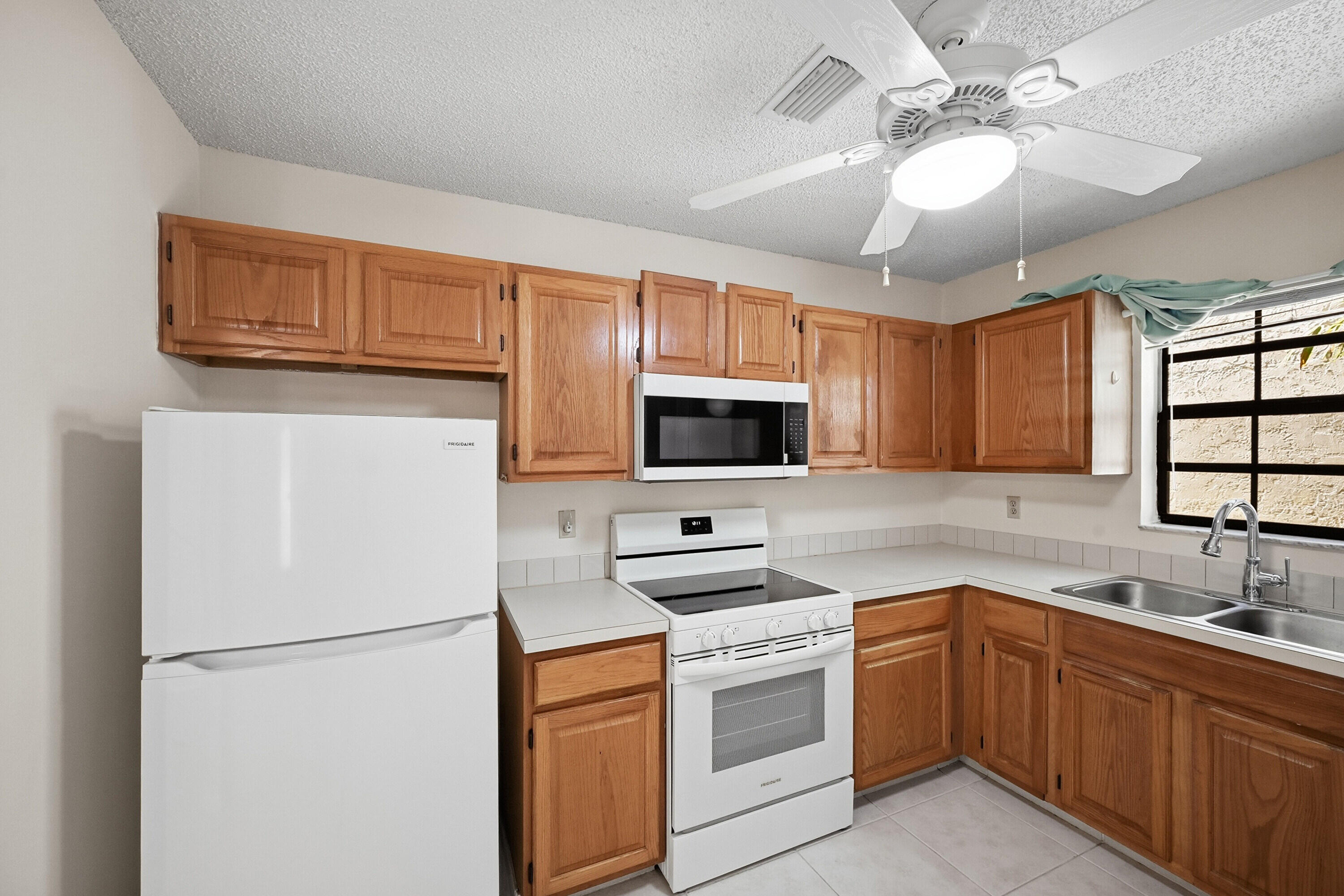 440 Ashwood Place Boca Raton, FL 33431 - Photo 11 of 32 a kitchen with cabinets stainless steel appliances and a sink