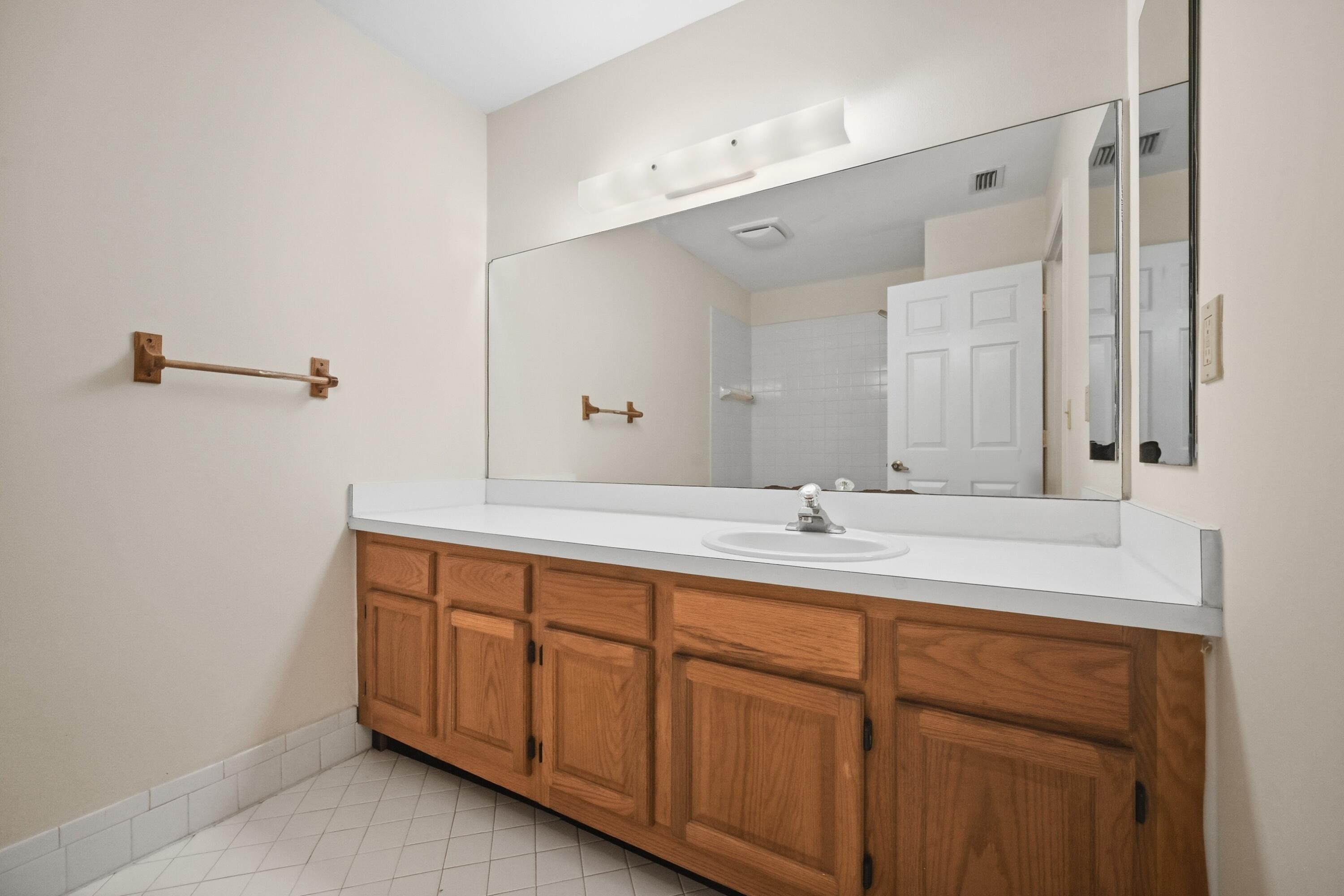440 Ashwood Place Boca Raton, FL 33431 - Photo 16 of 32 a bathroom with a sink and a mirror
