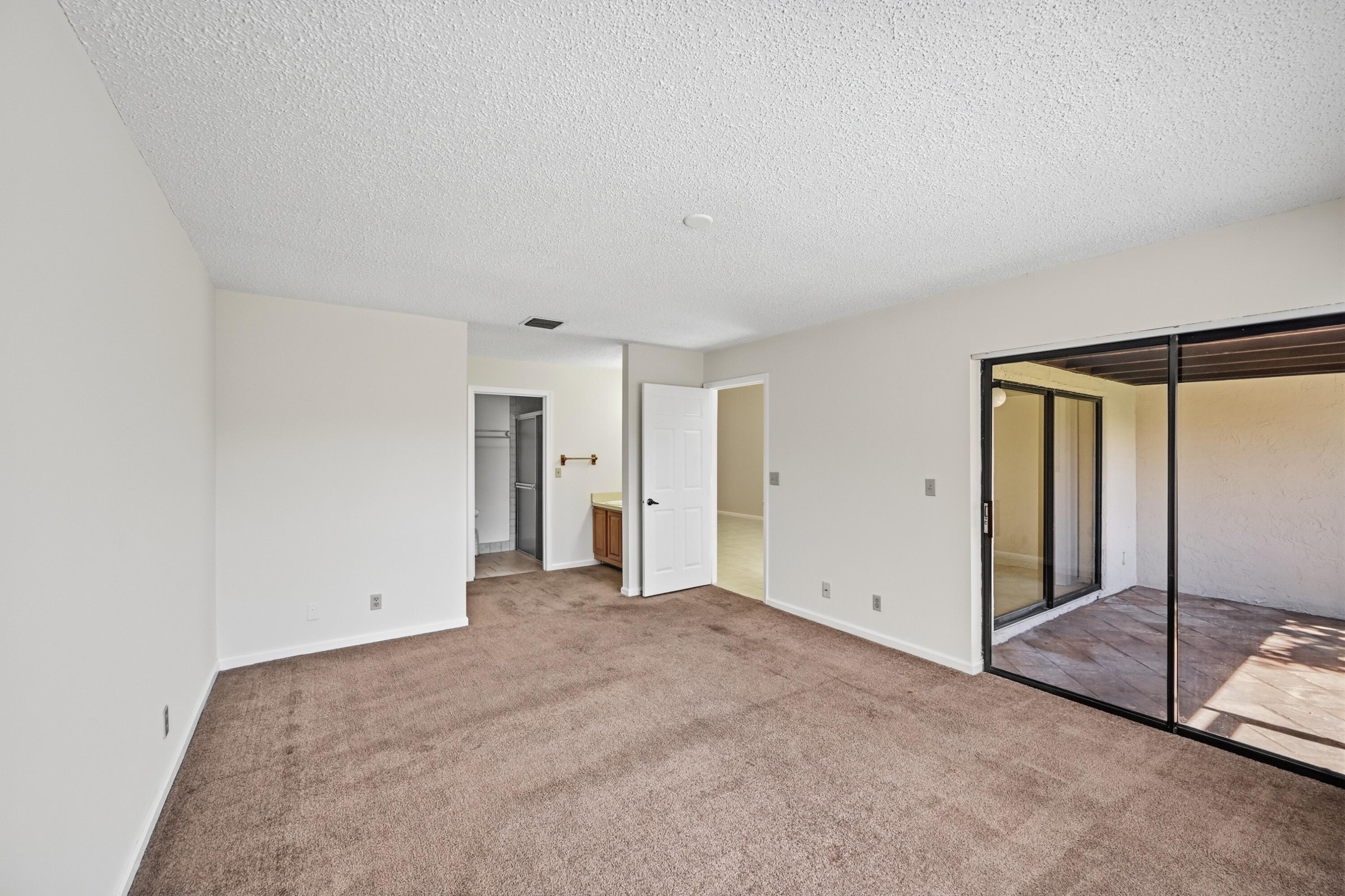 440 Ashwood Place Boca Raton, FL 33431 - Photo 20 of 32 an empty room with sliding glass door and shower