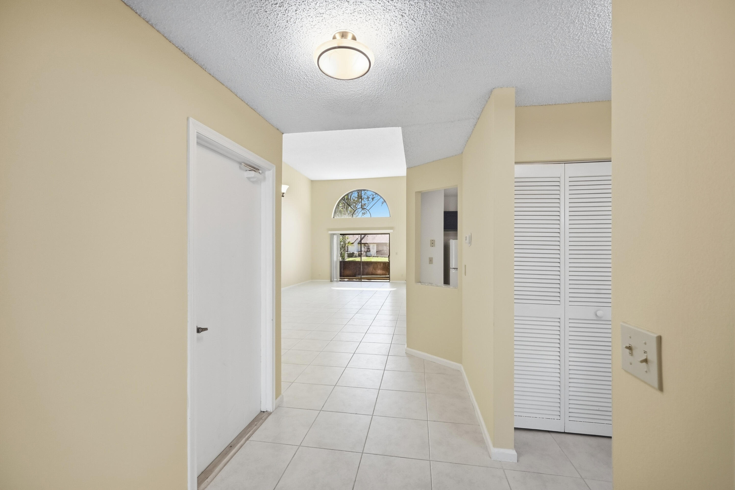 440 Ashwood Place Boca Raton, FL 33431 - Photo 4 of 32 a view of a hallway to rooms and wooden floor
