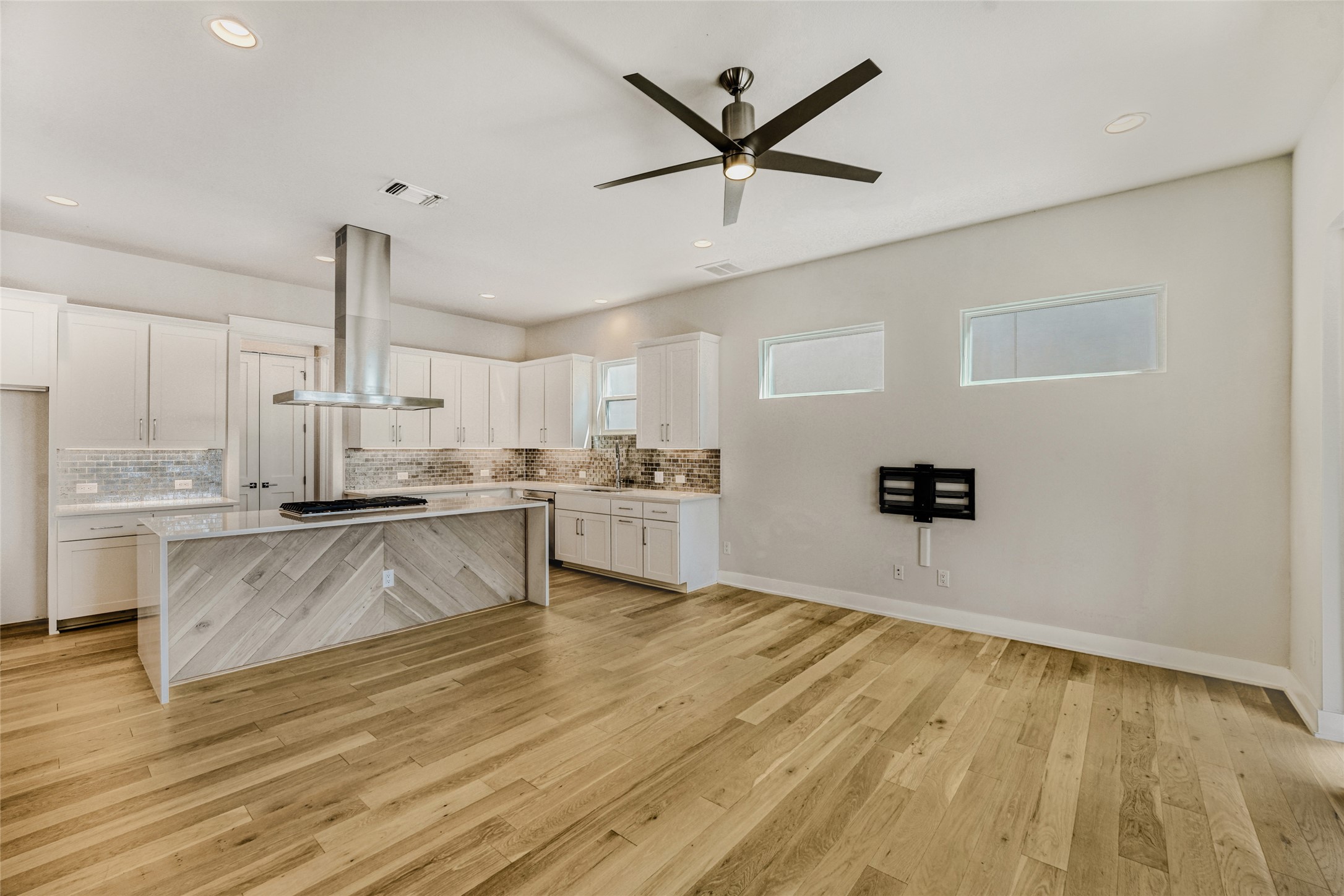 5002 Pecan Springs Road, Unit 6 Austin, TX 78723 - Photo 12 of 29 a large white kitchen with wooden floor