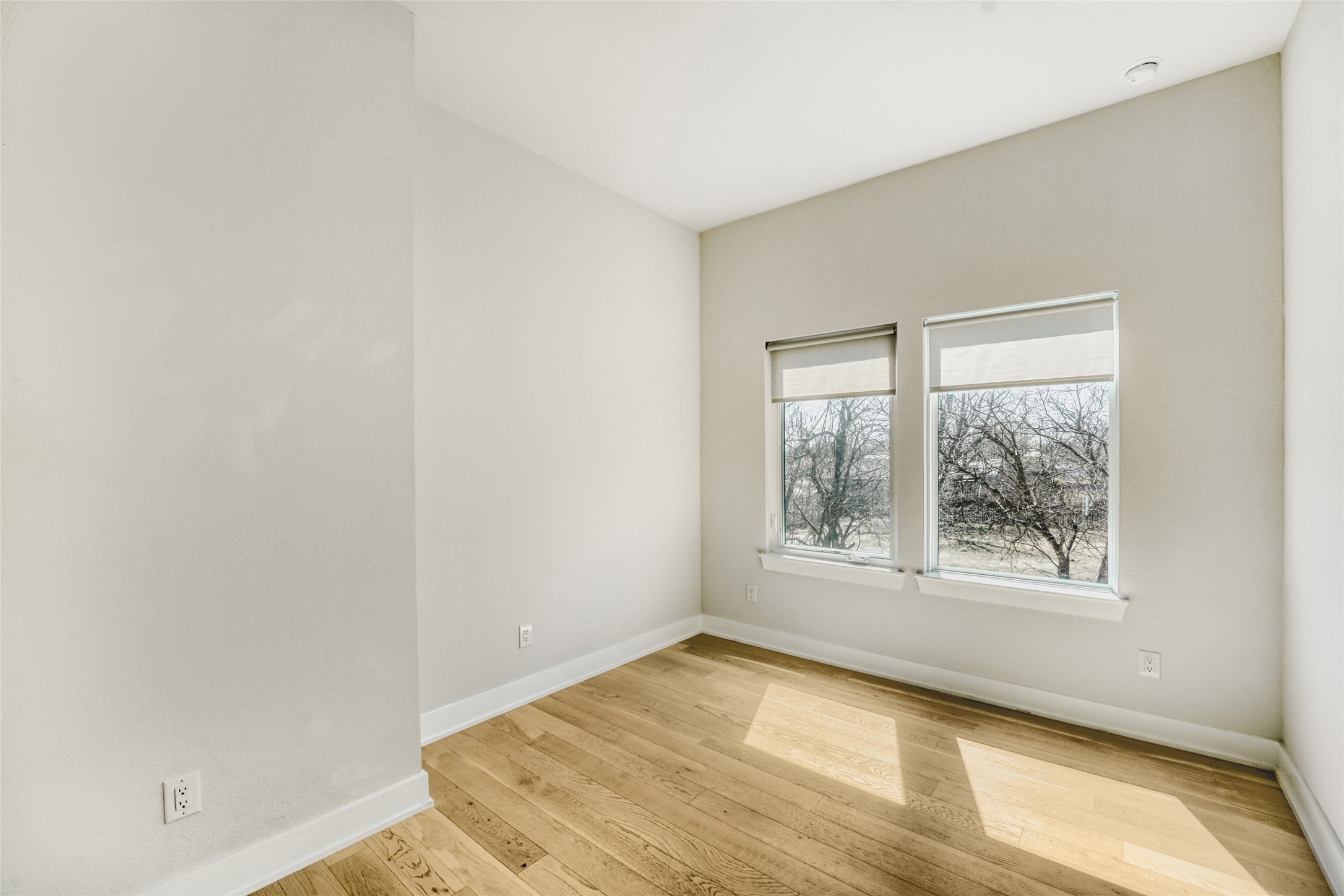 5002 Pecan Springs Road, Unit 6 Austin, TX 78723 - Photo 17 of 29 an empty room with wooden floor and windows