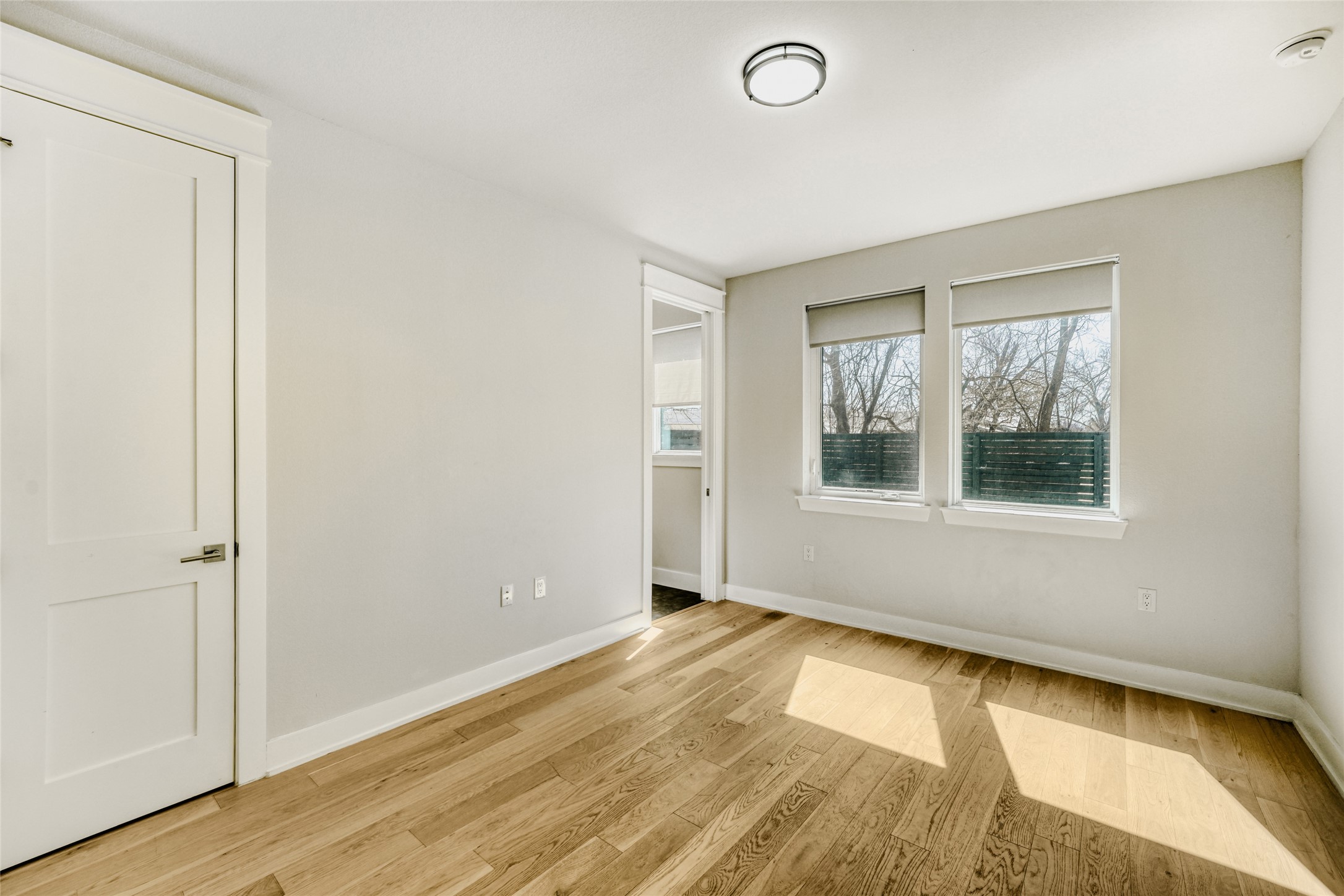 5002 Pecan Springs Road, Unit 6 Austin, TX 78723 - Photo 21 of 29 an empty room with wooden floor and windows