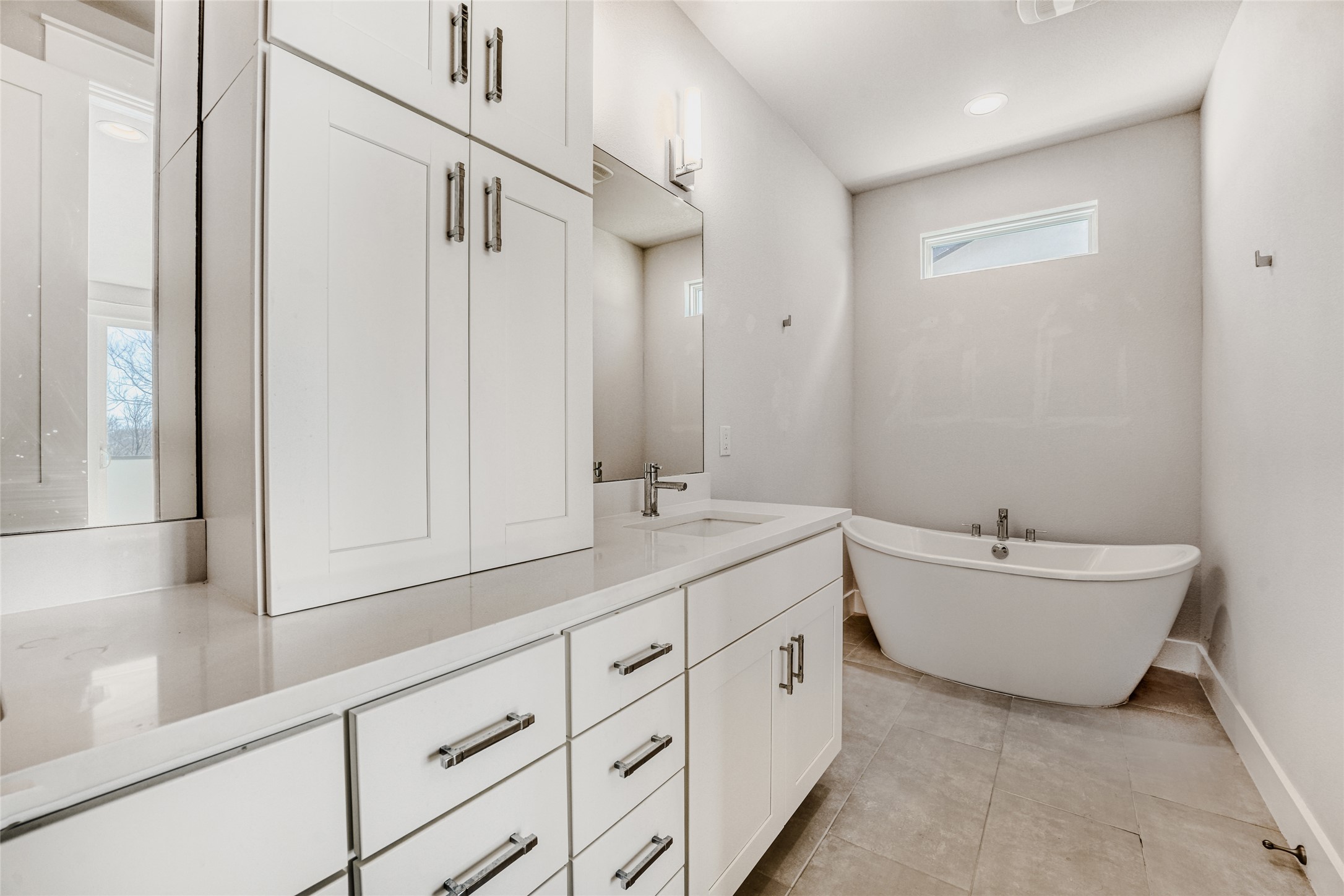 5002 Pecan Springs Road, Unit 6 Austin, TX 78723 - Photo 24 of 29 a bathroom with double vanity sink a mirror and a bathtub