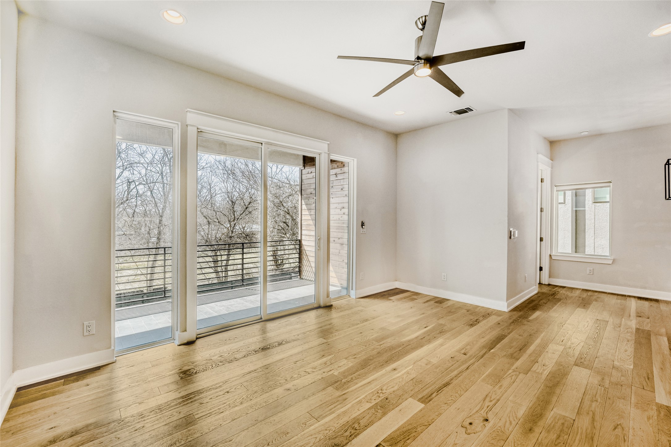 5002 Pecan Springs Road, Unit 6 Austin, TX 78723 - Photo 4 of 29 a view of an empty room with wooden floor and a window