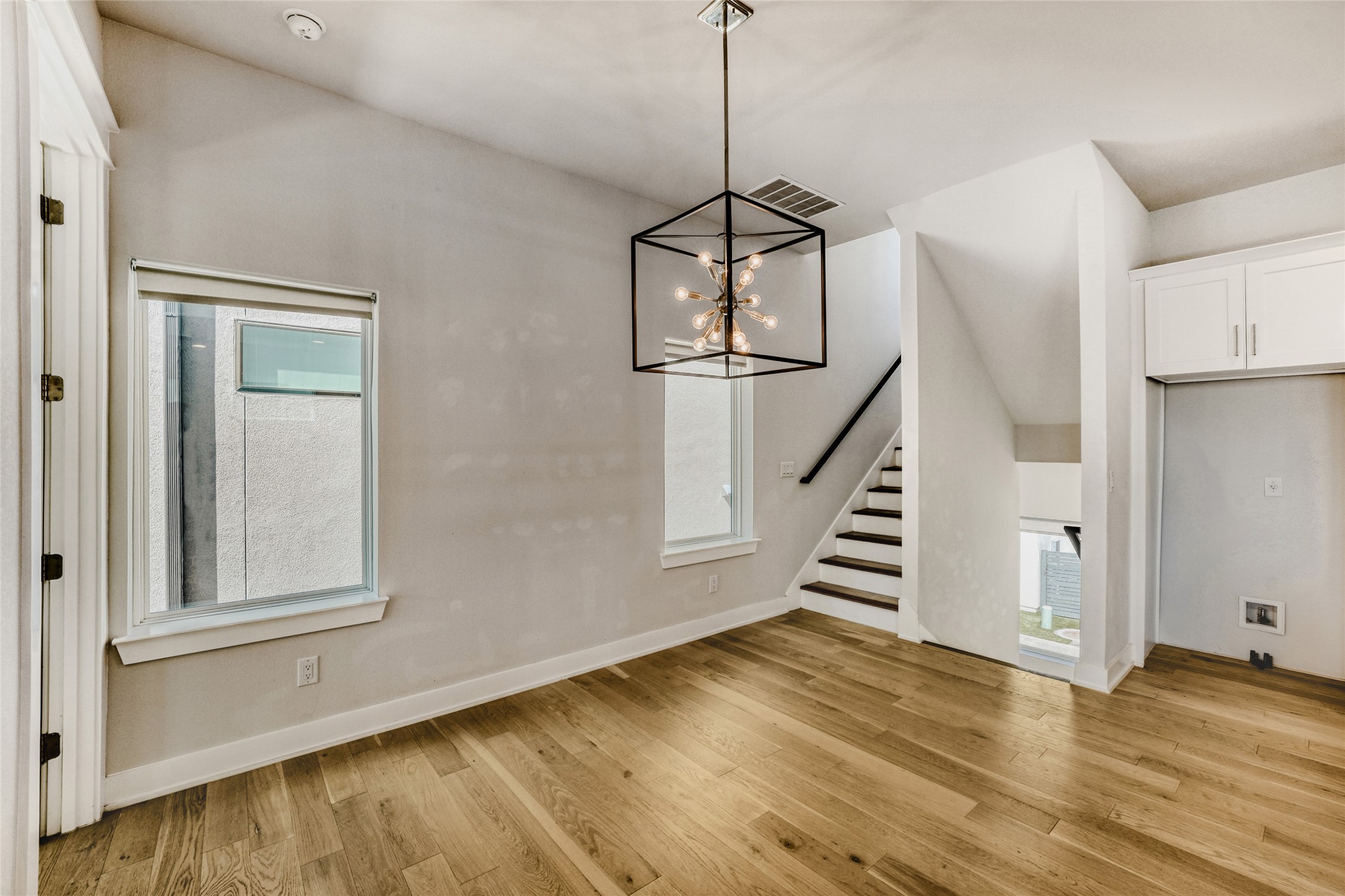5002 Pecan Springs Road, Unit 6 Austin, TX 78723 - Photo 5 of 29 a view of a room with wooden floor staircase and windows