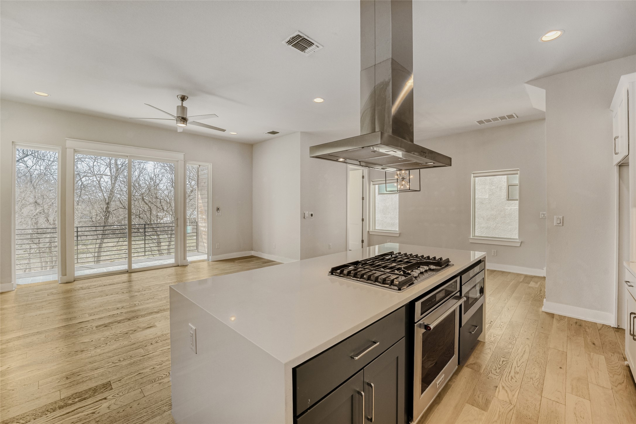 5002 Pecan Springs Road, Unit 6 Austin, TX 78723 - Photo 8 of 29 a kitchen with stainless steel appliances granite countertop a stove a sink dishwasher and a dining table with wooden floor