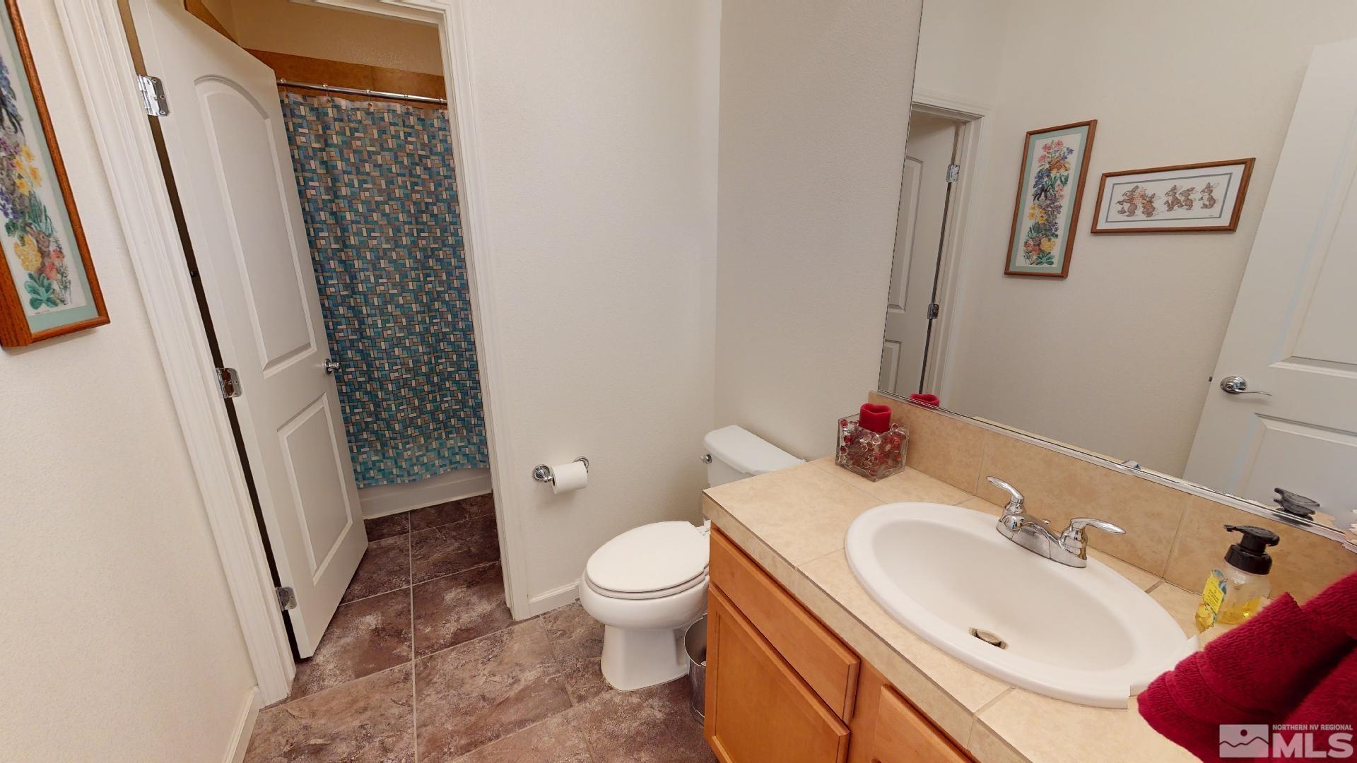 9810 Kerrydale Court Reno, NV 89521 - Photo 14 of 40 a bathroom with a sink toilet and shower