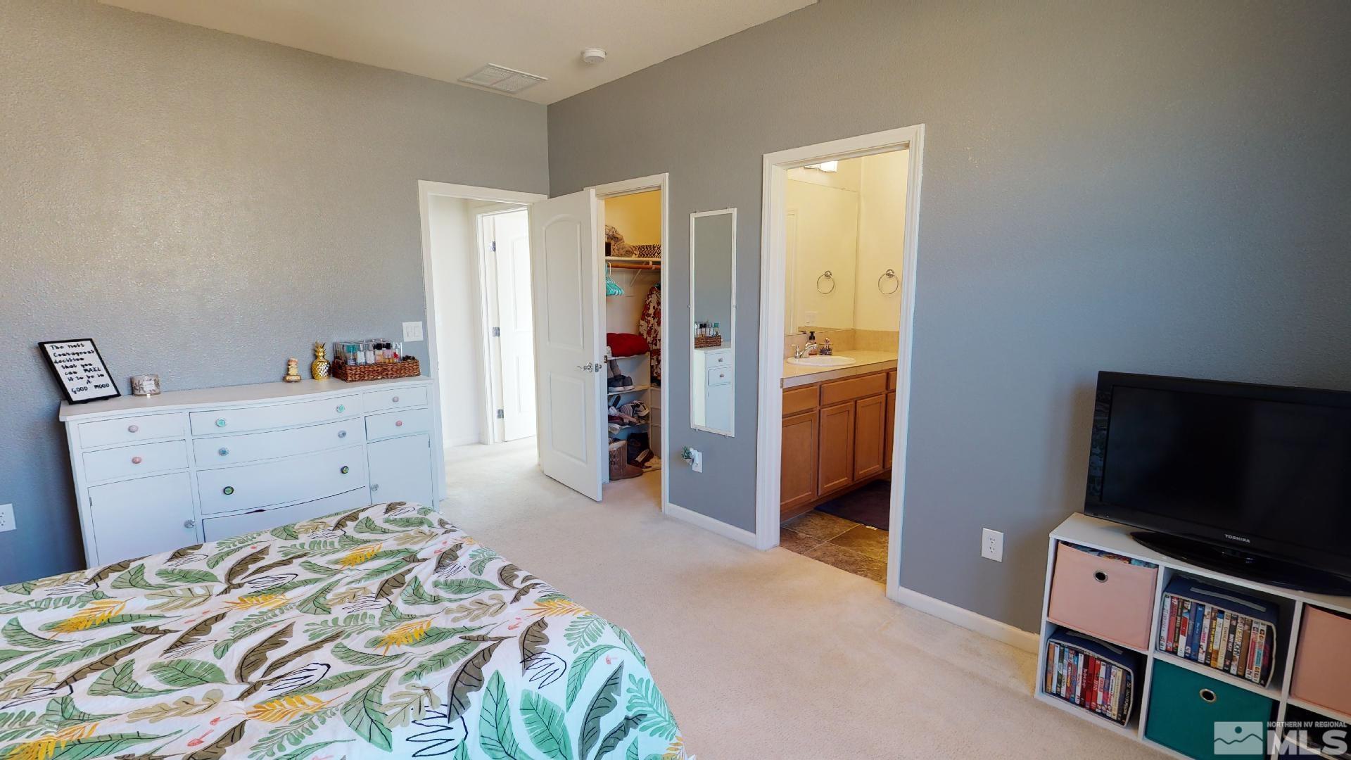 9810 Kerrydale Court Reno, NV 89521 - Photo 19 of 40 a bedroom with a bed and a flat screen tv