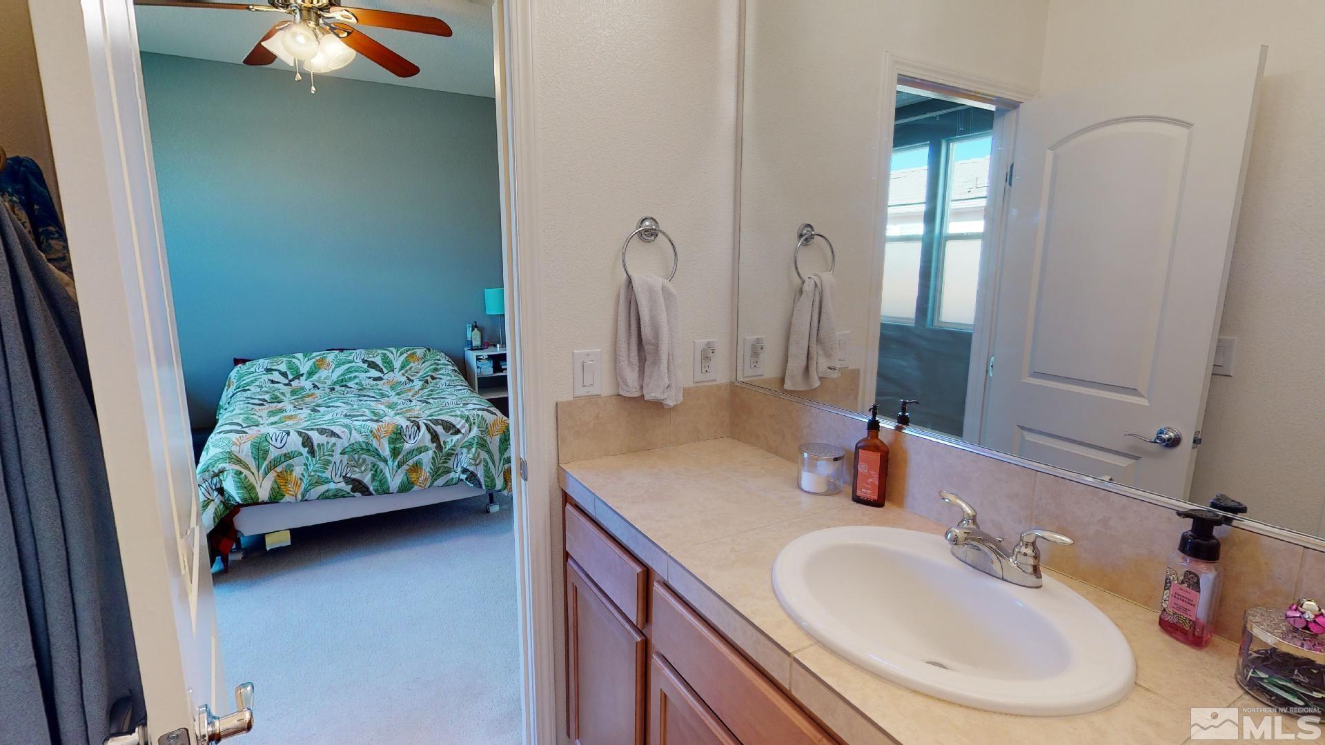 9810 Kerrydale Court Reno, NV 89521 - Photo 21 of 40 a bathroom with a sink and a mirror