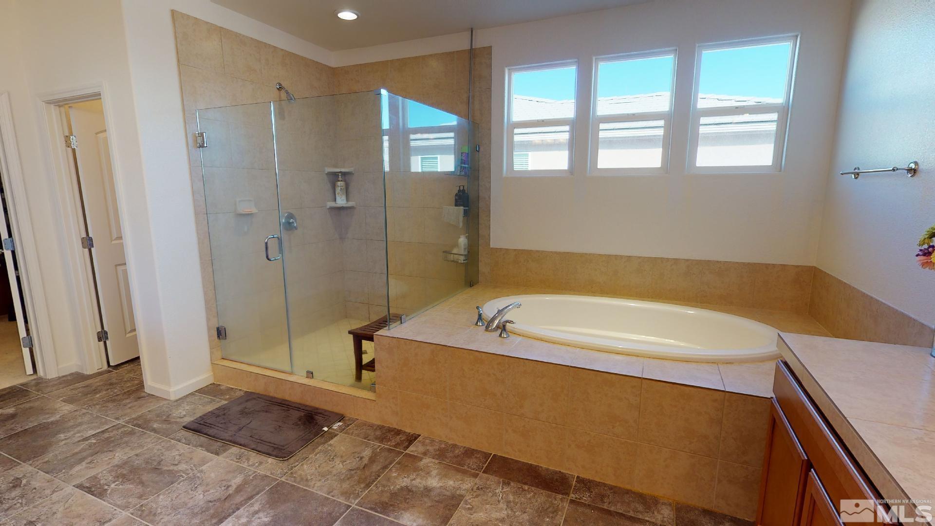 9810 Kerrydale Court Reno, NV 89521 - Photo 23 of 40 a bathroom with a tub a sink and a shower