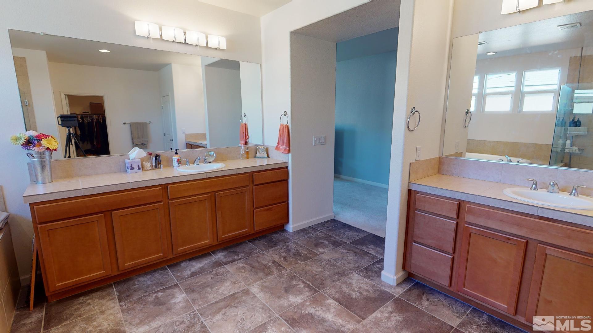 9810 Kerrydale Court Reno, NV 89521 - Photo 24 of 40 a spacious bathroom with a double vanity sink and a mirror
