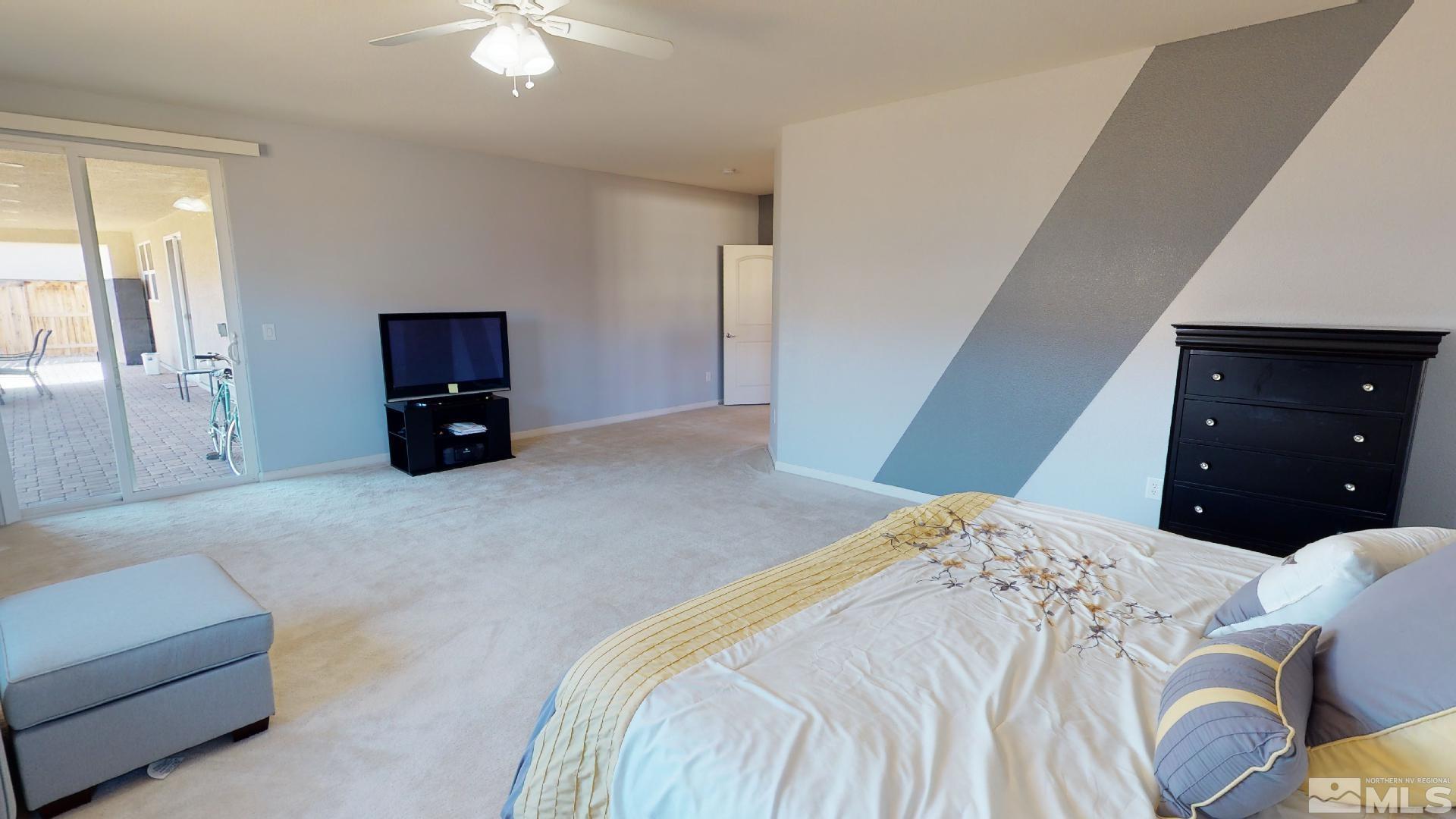 9810 Kerrydale Court Reno, NV 89521 - Photo 30 of 40 a bedroom with a bed and a couch