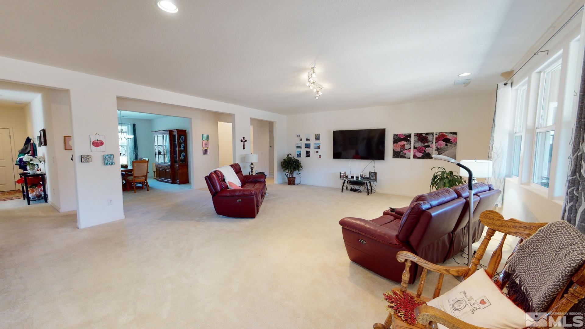 9810 Kerrydale Court Reno, NV 89521 - Photo 3 of 40 a living room with furniture a flat screen tv and a window