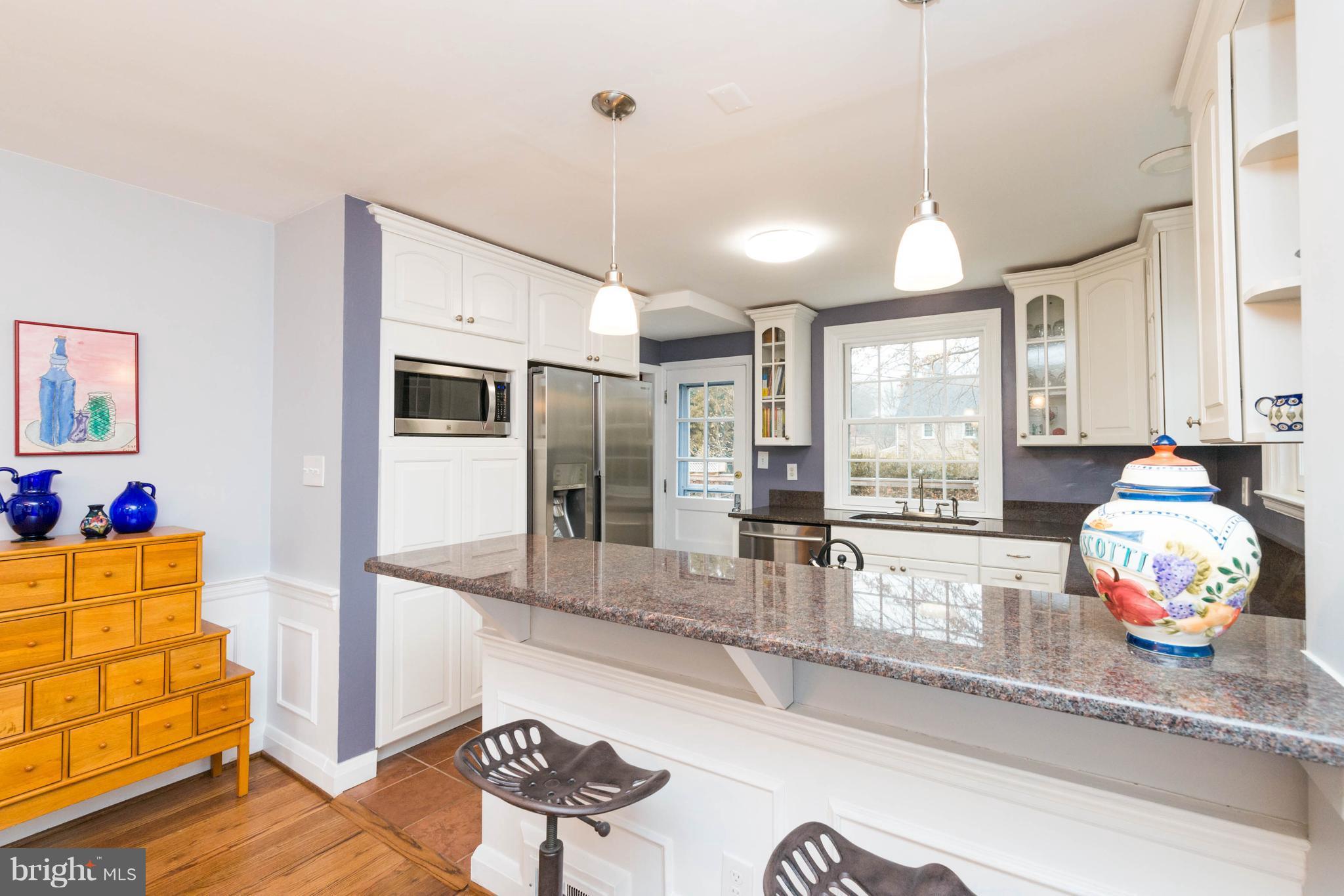 a kitchen with stainless steel appliances granite countertop a sink and refrigerator