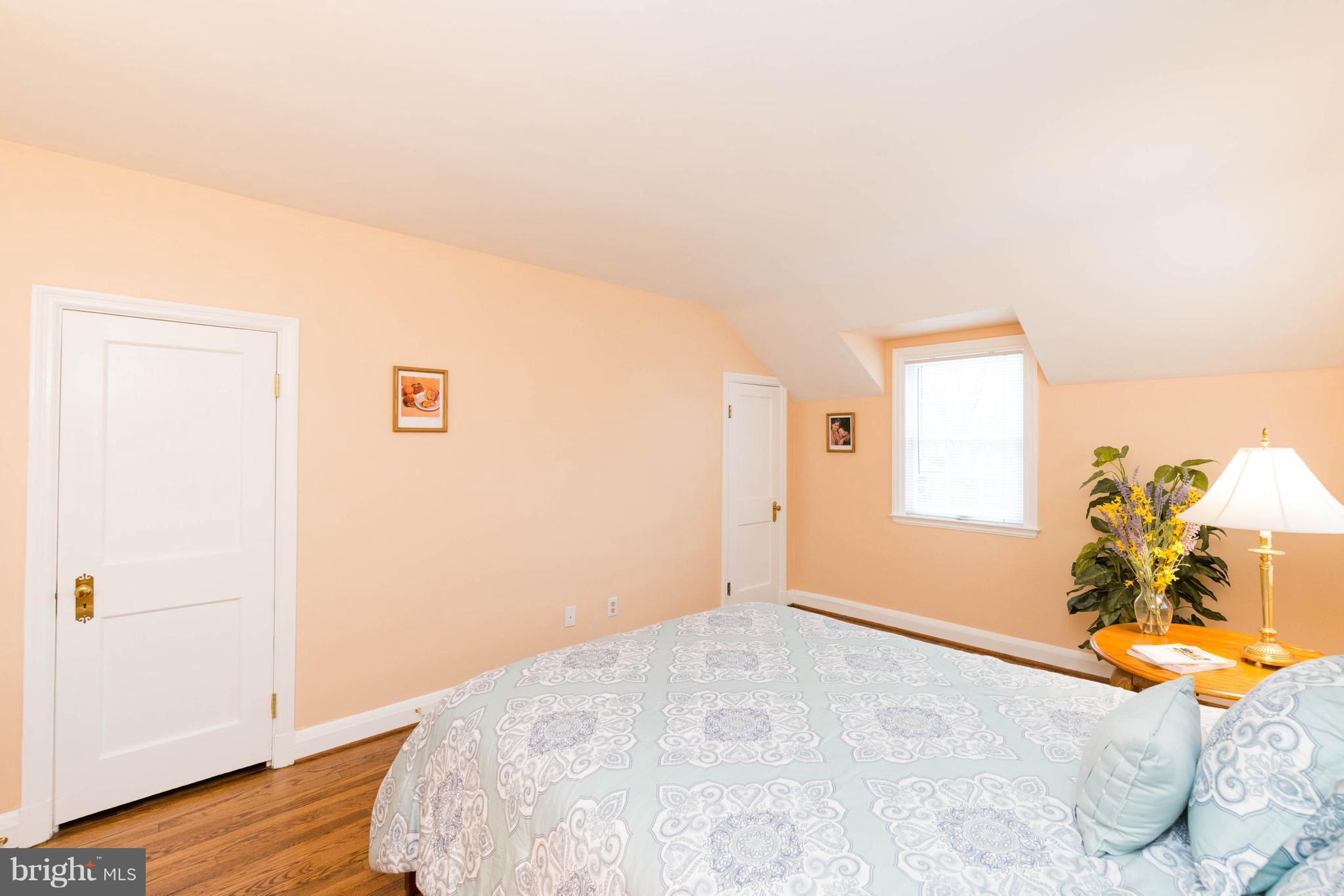 624 Wilton Road Baltimore, MD 21286 - Photo 16 of 30 a bedroom with a bed and a chandelier