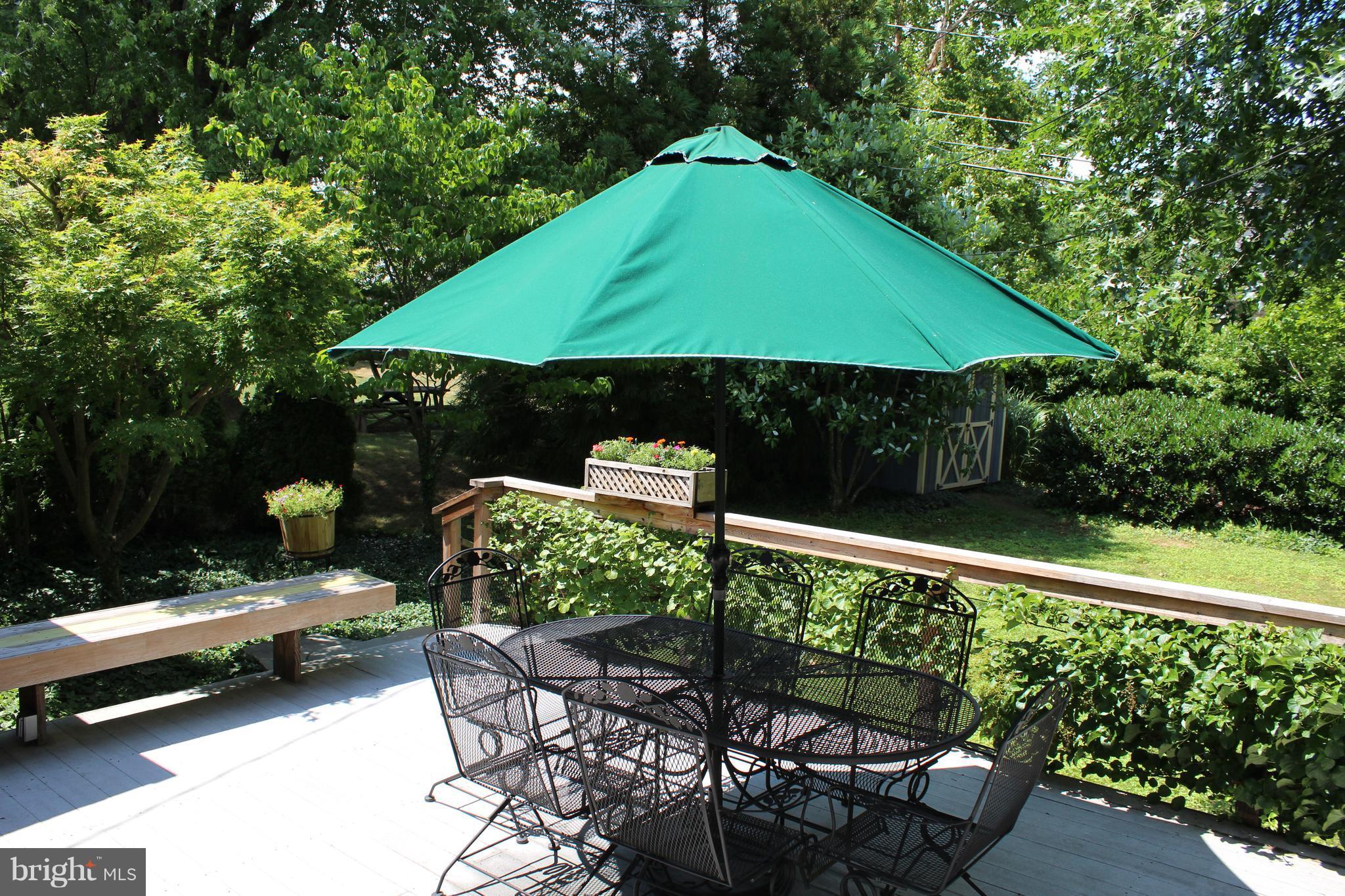 624 Wilton Road Baltimore, MD 21286 - Photo 27 of 30 a patio with tables and chairs under an umbrella