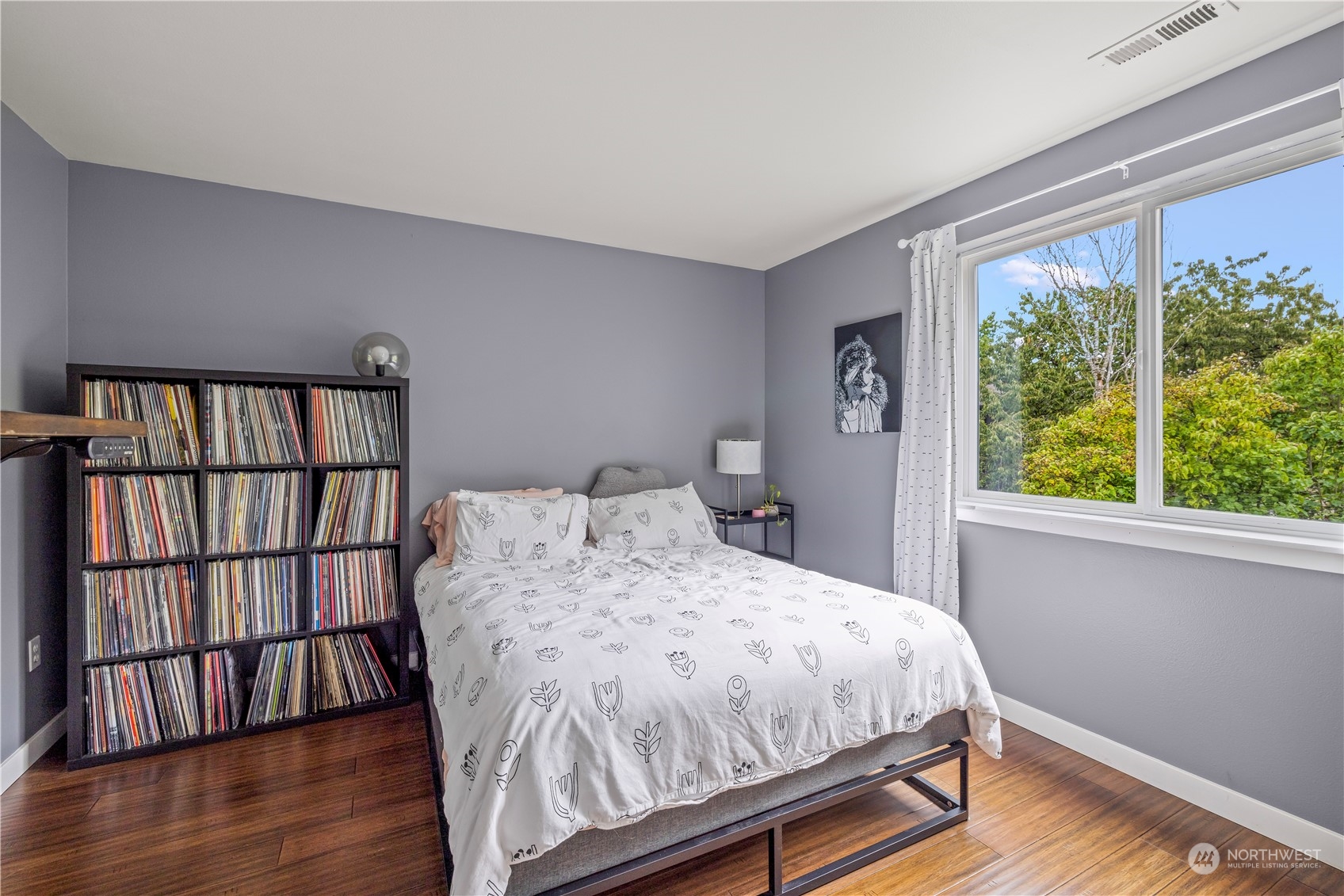 2847 Southwest Dakota Street Seattle, WA 98126 - Photo 21 of 39 a bedroom with a bed and wooden floor