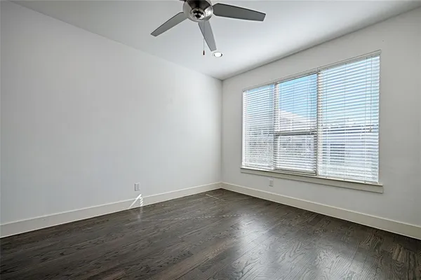 a view of a livingroom with wooden floor and a window