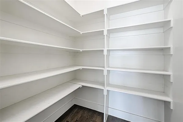 a view of walk in closet with empty racks