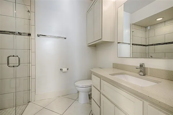 a bathroom with a sink toilet and shower