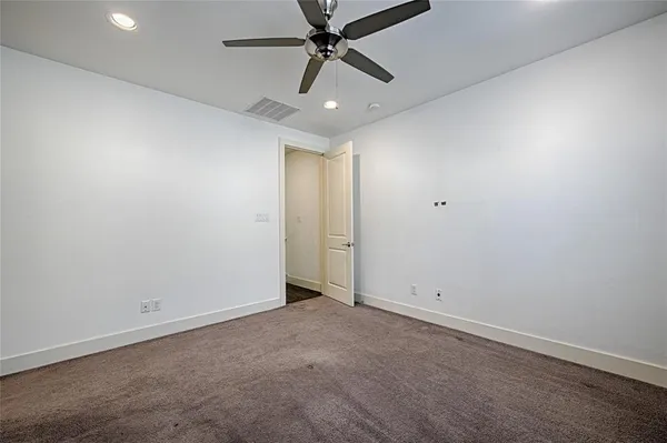 an empty room with chandelier fan
