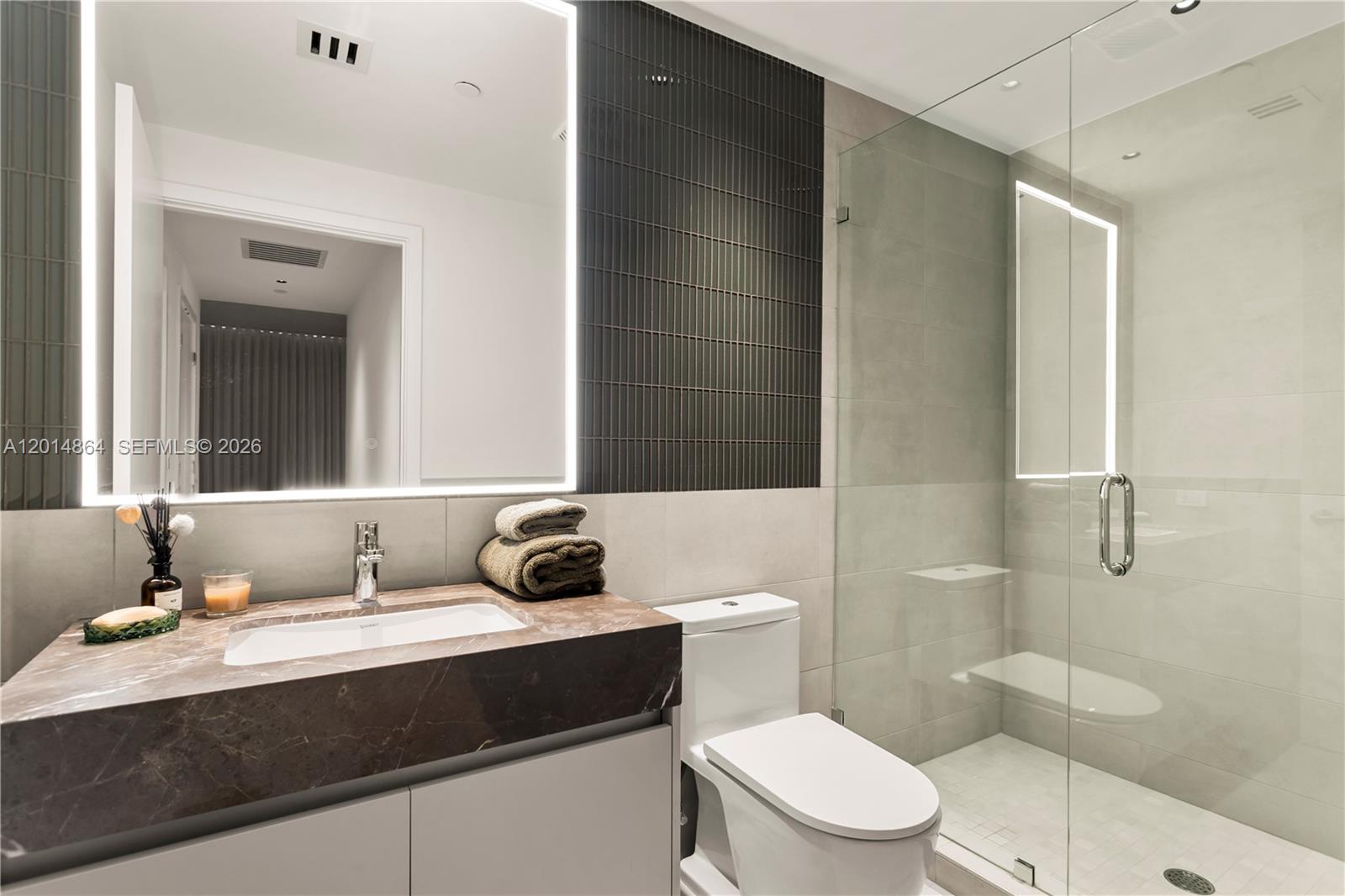 500 Alton Road, Unit 1601 Miami Beach, FL 33139 - Photo 12 of 20 a bathroom with a sink toilet vanity and shower