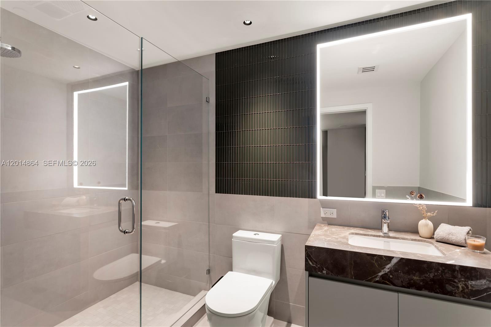 500 Alton Road, Unit 1601 Miami Beach, FL 33139 - Photo 15 of 20 a bathroom with a granite countertop sink toilet and shower