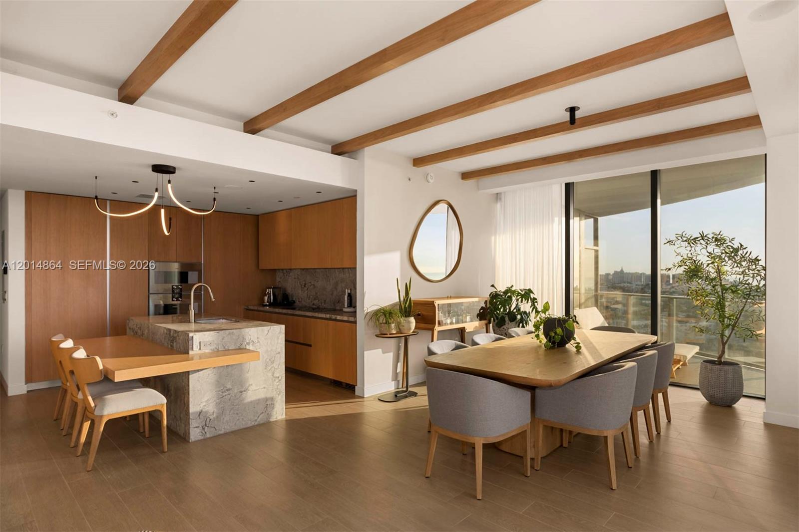 500 Alton Road, Unit 1601 Miami Beach, FL 33139 - Photo 4 of 20 a dining room with wooden floor a glass table and chairs