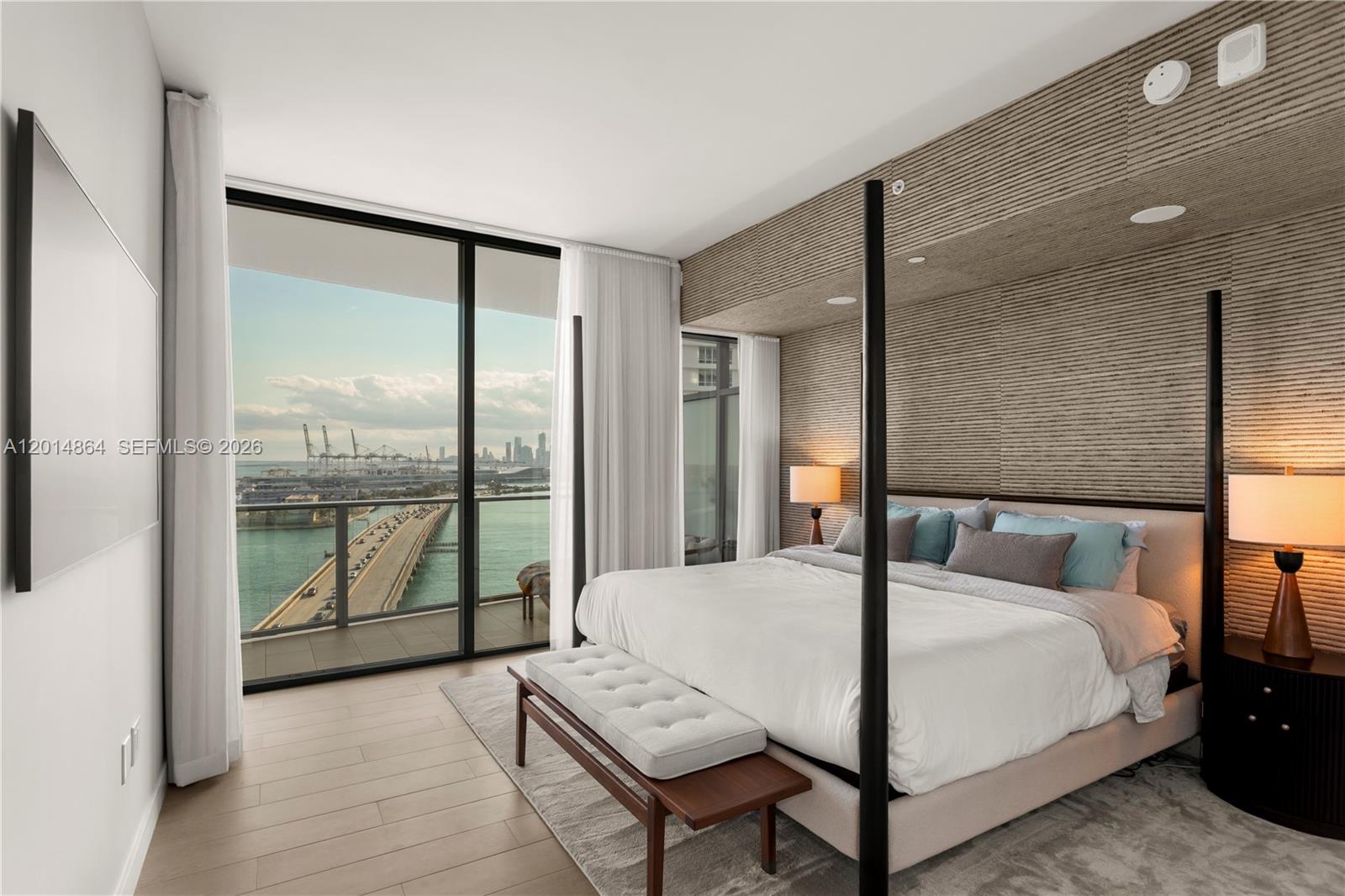 500 Alton Road, Unit 1601 Miami Beach, FL 33139 - Photo 6 of 20 a large bedroom with a bed and large window