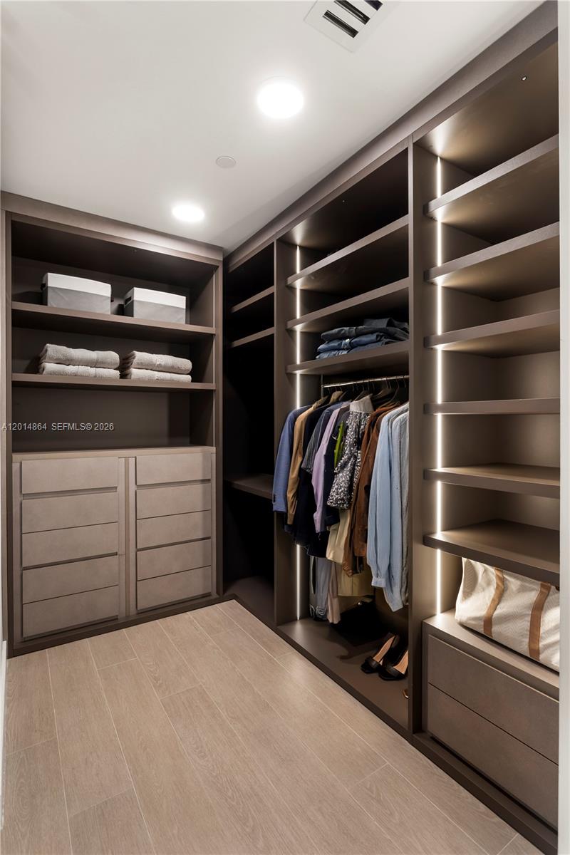 500 Alton Road, Unit 1601 Miami Beach, FL 33139 - Photo 9 of 20 a view of walk in closet with clothes and shoes