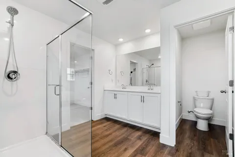 a bathroom with a shower sink and toilet