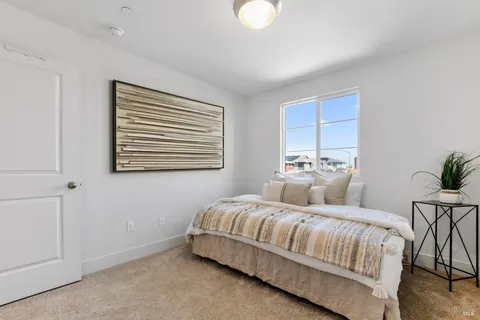 a bedroom with a large bed and a window